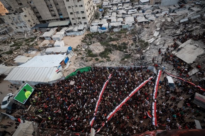 C:\Users\Sabah\Downloads\Palestinians watch a World Cup match amidst the ruins in Gaza CityGAZA CITY, GAZA, PALESTINE - J.jpg